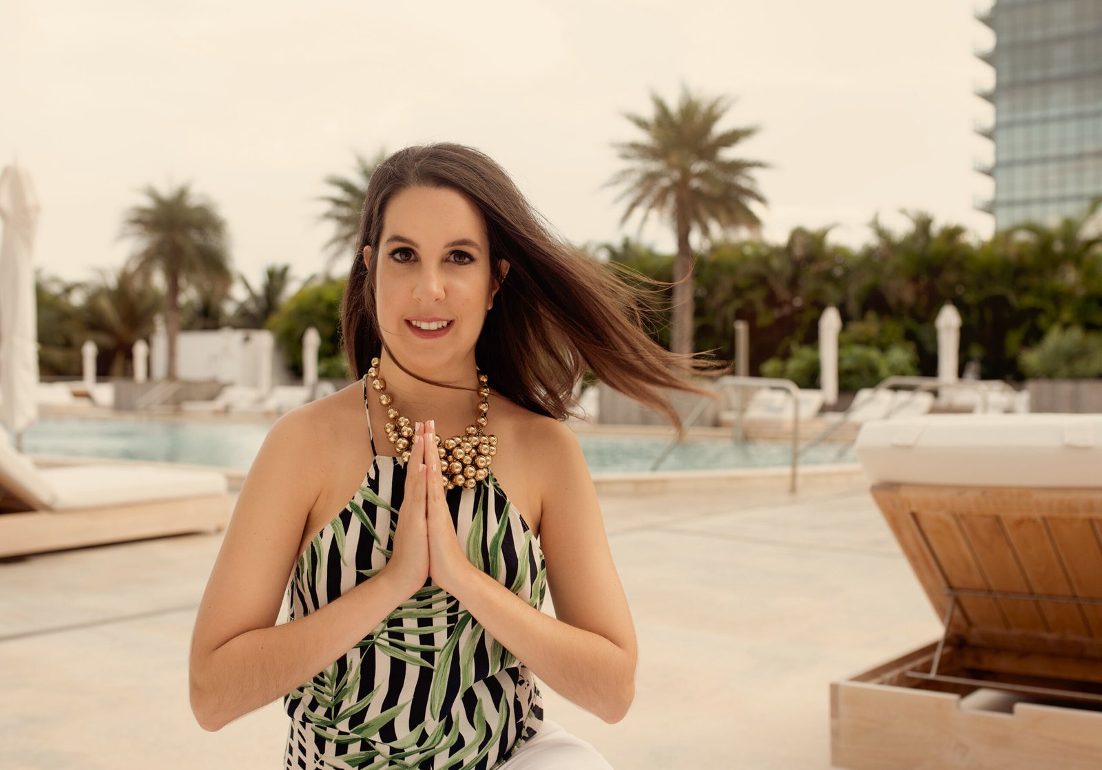 Amanda Abella, hands in prayer, in warm golden light